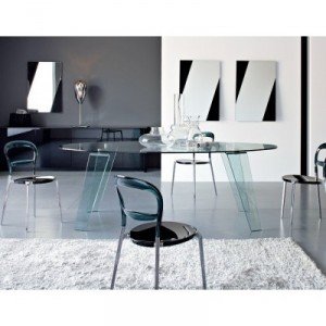 Glass dining table in a minimal interior setting