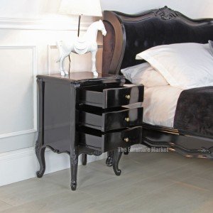 French noir black painted three drawer bedside - side view